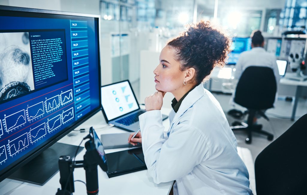 Computer, screen and scientist in laboratory with thinking, planning and analysis with medical rese.